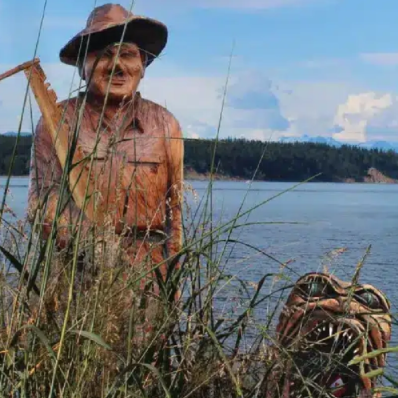 chansaw carved figures on the beach.