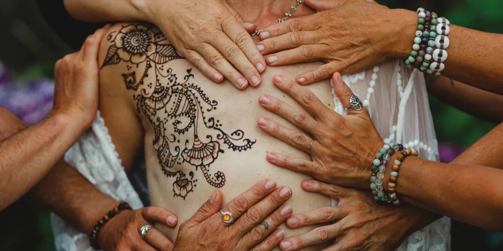 Women's hands holding space during healing through art experience after breast implant illness