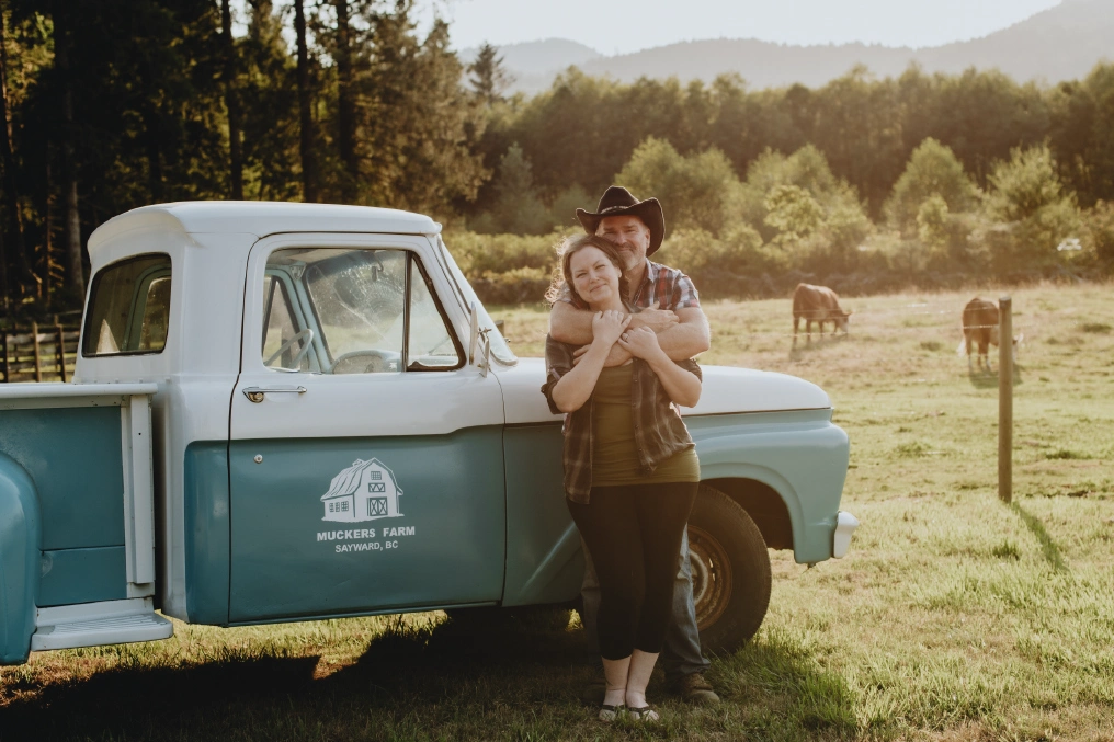 Mucker's Farm owners with vintage truck on their off-grid farm in Sayward, BC
