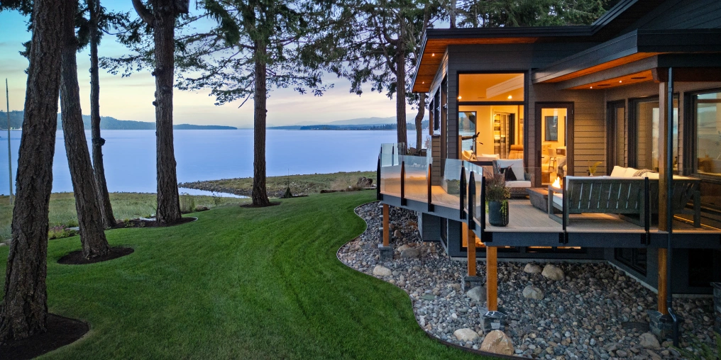 Waterfront home construction showing helical piles foundation and coastal landscaping on Vancouver Island oceanfront property