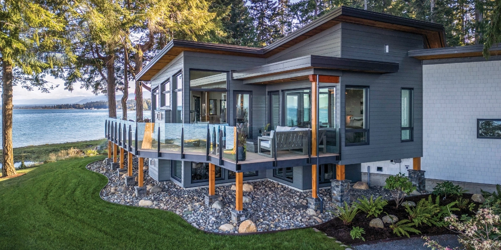 Modern coastal home building project in Comox Valley showing completed waterfront construction with ocean access