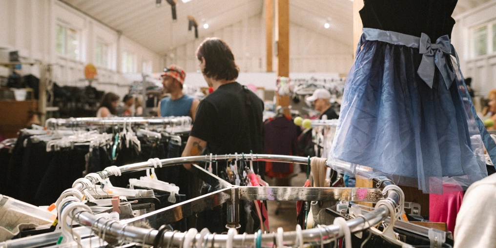 Bike parts and donated items at Hornby Island Free Store with islanders browsing in background