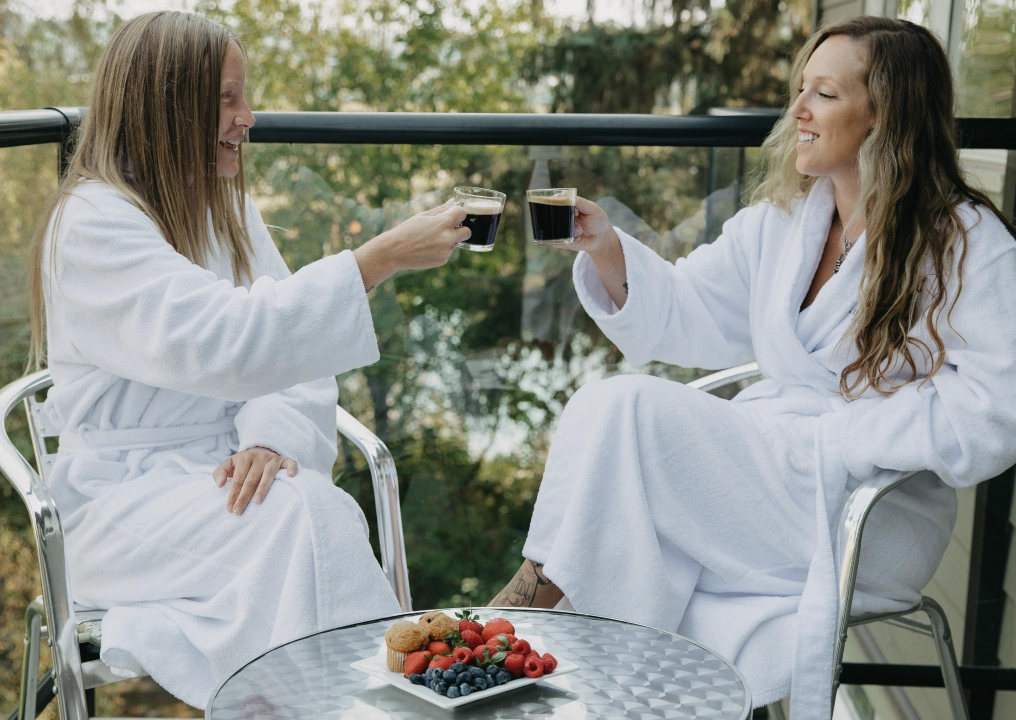 Guests in robes enjoying coffee on private balcony at Old House Hotel and Ohspa Courtenay