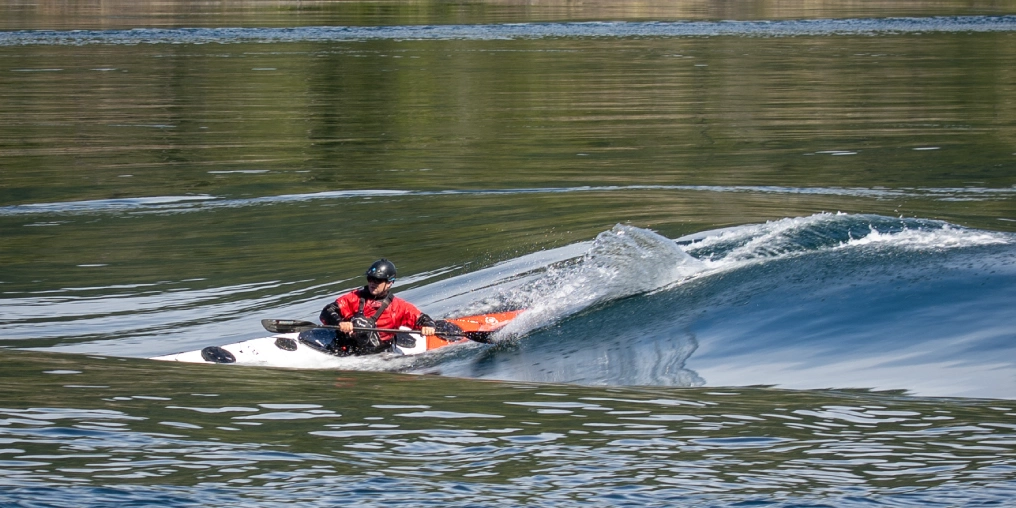 Kayaker surfing standing wave in tidal currents near Quadra Island