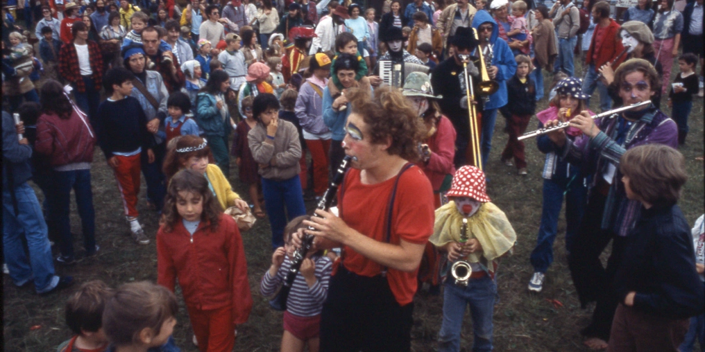 Creativity and community Musicians performing at the Comox Valley Renaissance Faire with crowd gathered, showcasing the Arts Alliance's community events in the 1970s-80s