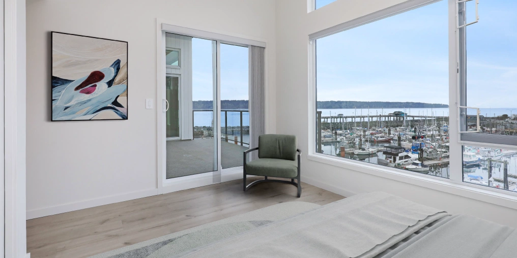 compact kitchen design with ceiling-height cabinets pendant lighting and waterfront view