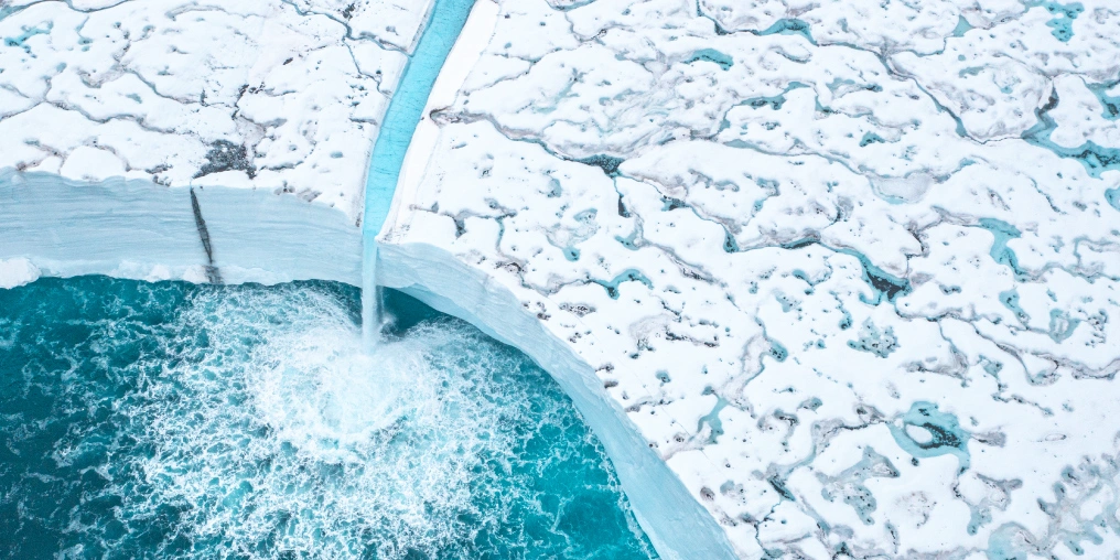 Aerial view of an expedition ship navigating Arctic pack ice in Svalbard