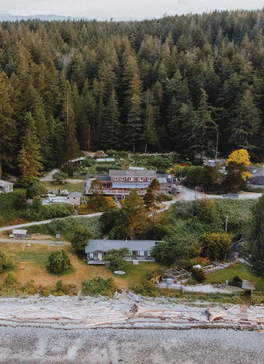 Aerial view of Hollyhock retreat centre on Cortes Island, surrounded by old-growth forest and shoreline