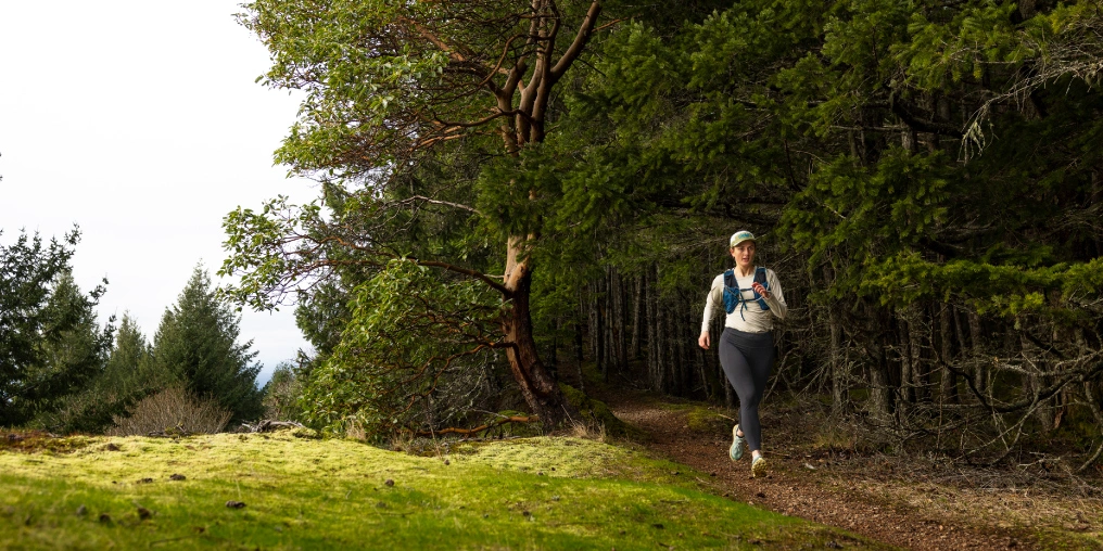 Trail runner on Hornby Island hiking trails near Mount Geoffrey, Gulf Islands BC