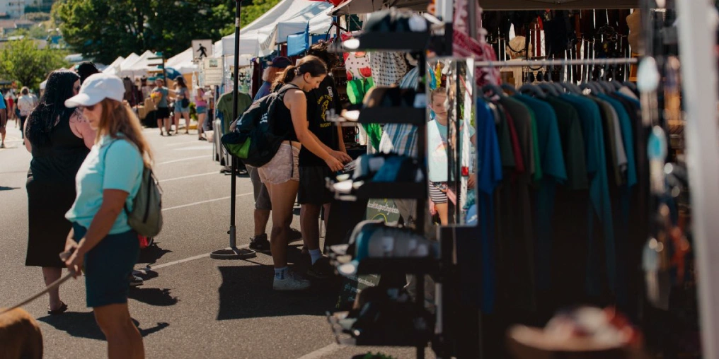 Shoppers browsing vendor stalls along Shopper's Row at the Campbell River Farmers Market