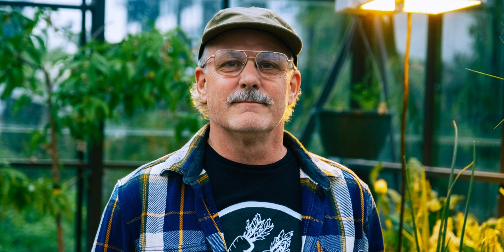 Growing food, joy, and resilience at the Parksville Community Gardens A volunteer at the community garden greenhouse, serving the Parksville and Qualicum Beach area