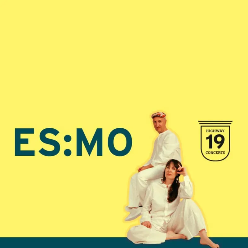 Elizabeth Shepherd and Michael Occhipinti sitting in front of a bright yellow background