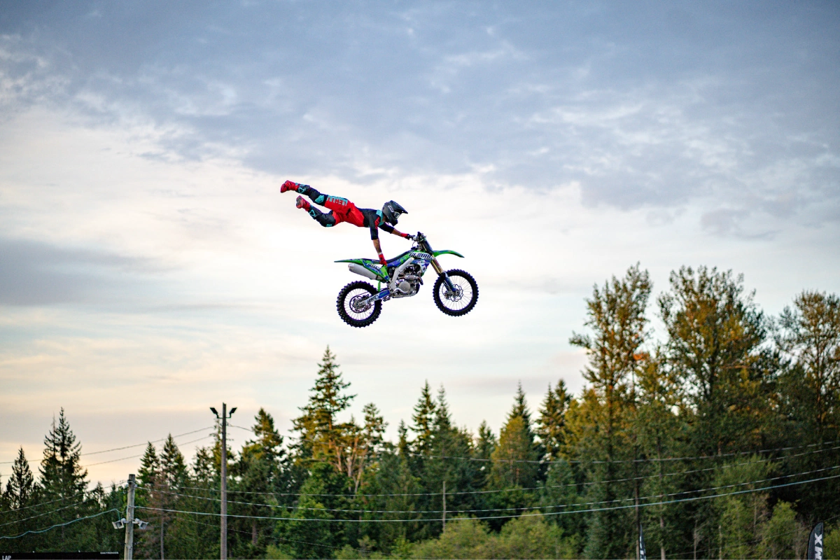 kennedy-armstrong-dirt-bike-jumper A dirt biker high in the air an hanging off of their bike