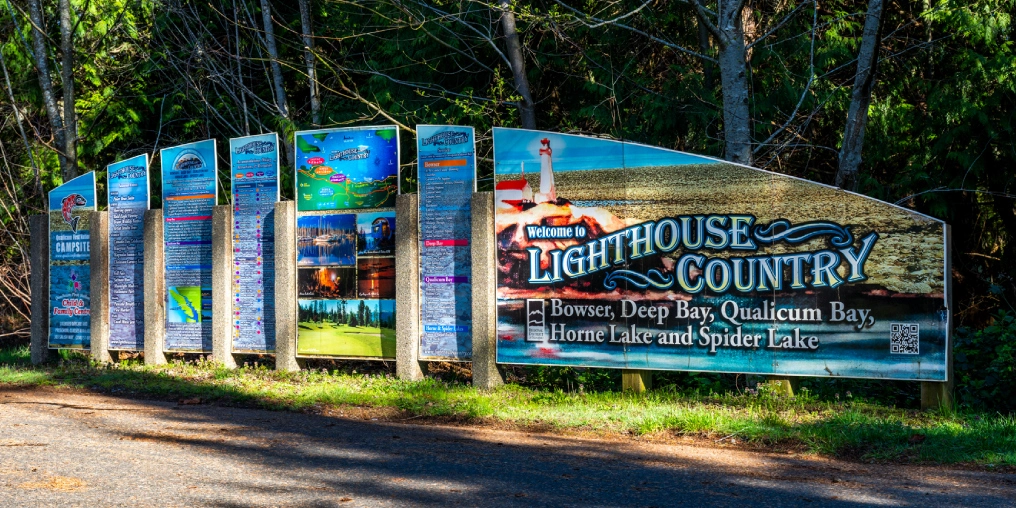 Welcome to Lighthouse Country sign listing Bowser, Deep Bay, Qualicum Bay, Horne Lake and Spider Lake, BC