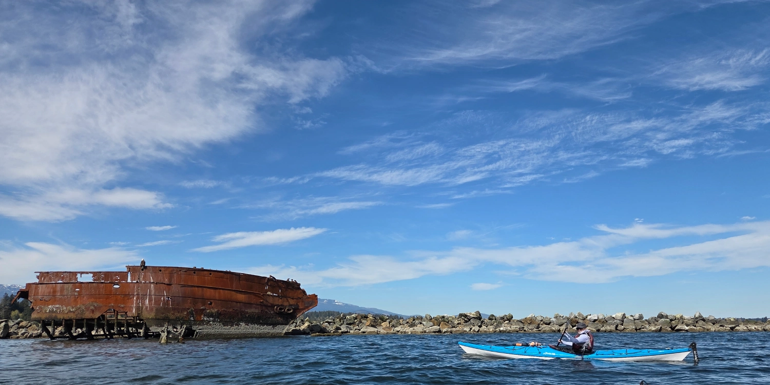 royston-wrecks-kayak-wide Kayaker paddling past the Royston Wrecks shipwreck along the shoreline