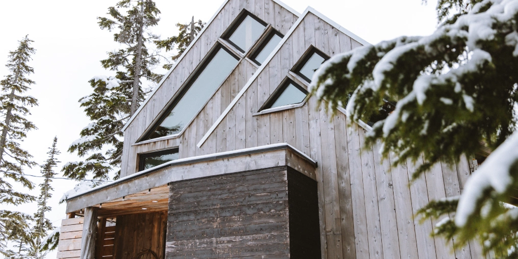 Building Basecamp Exterior of the rebuilt cabin on Mount Washington, covered in fresh snow