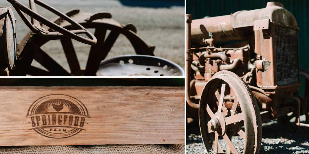 Rusted vintage tractor steering wheel and seat, a wooden board branded with the Springford Farm logo, and an antique tractor engine and spoked wheel